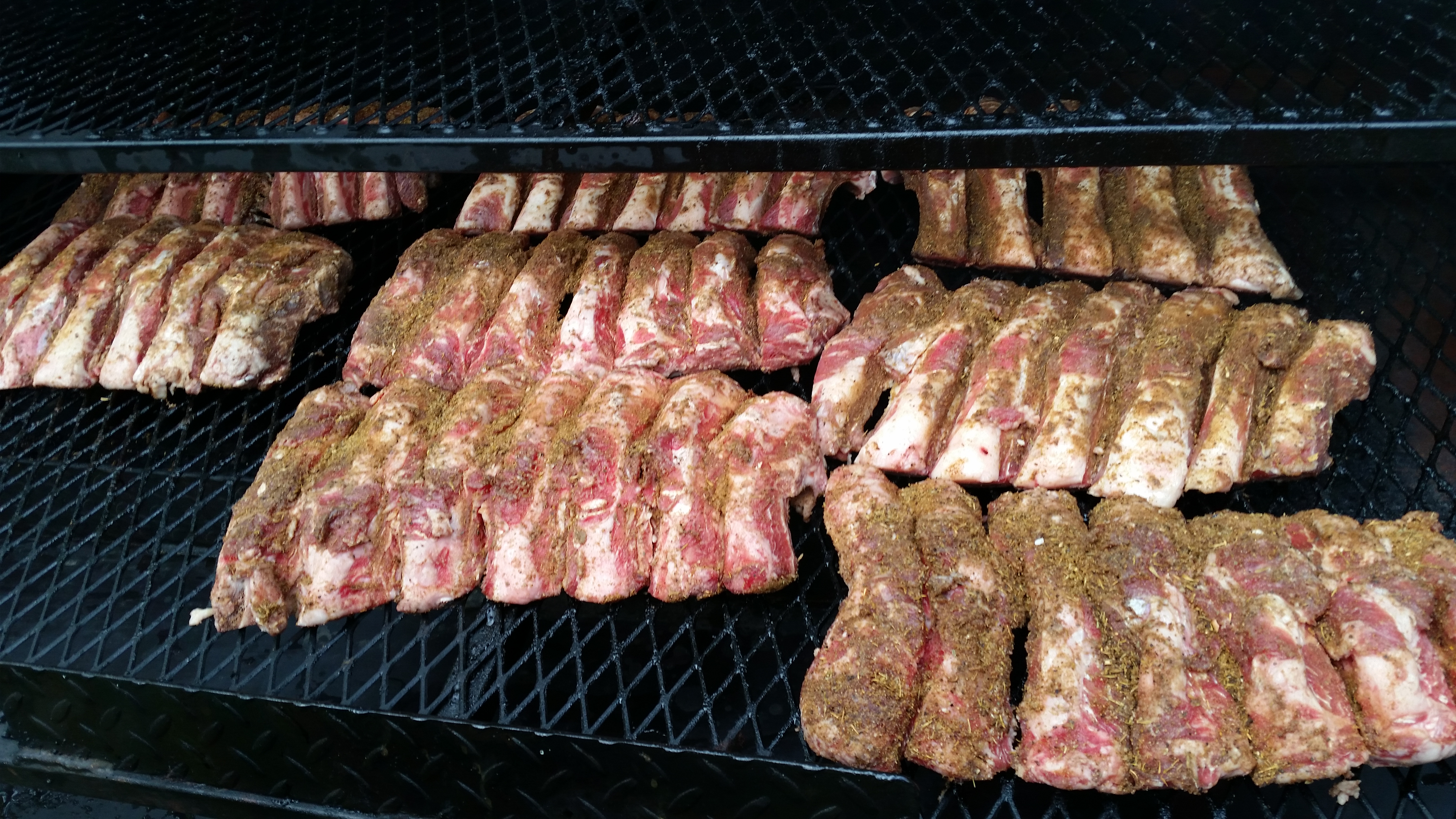 Baby back ribs smoking low and slow with beautiful caramelization