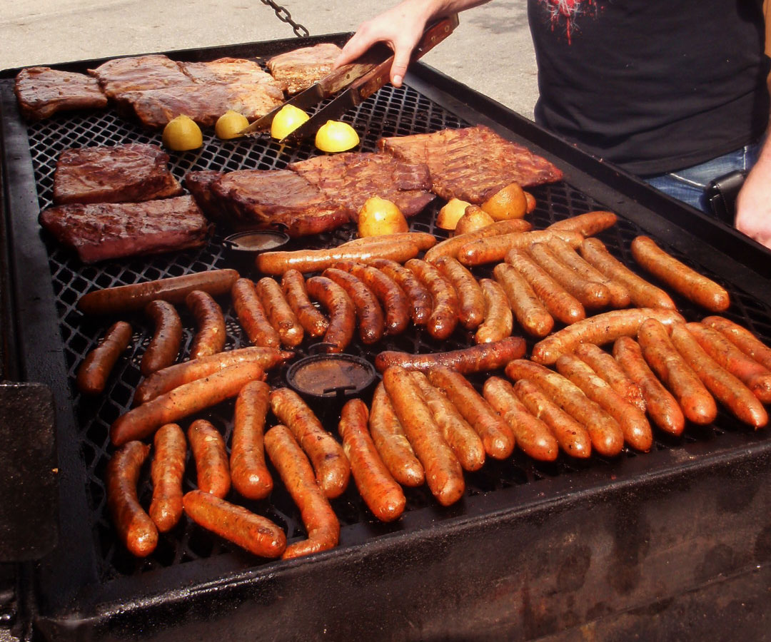 Sausages and steaks on the grill for a classic BBQ spread